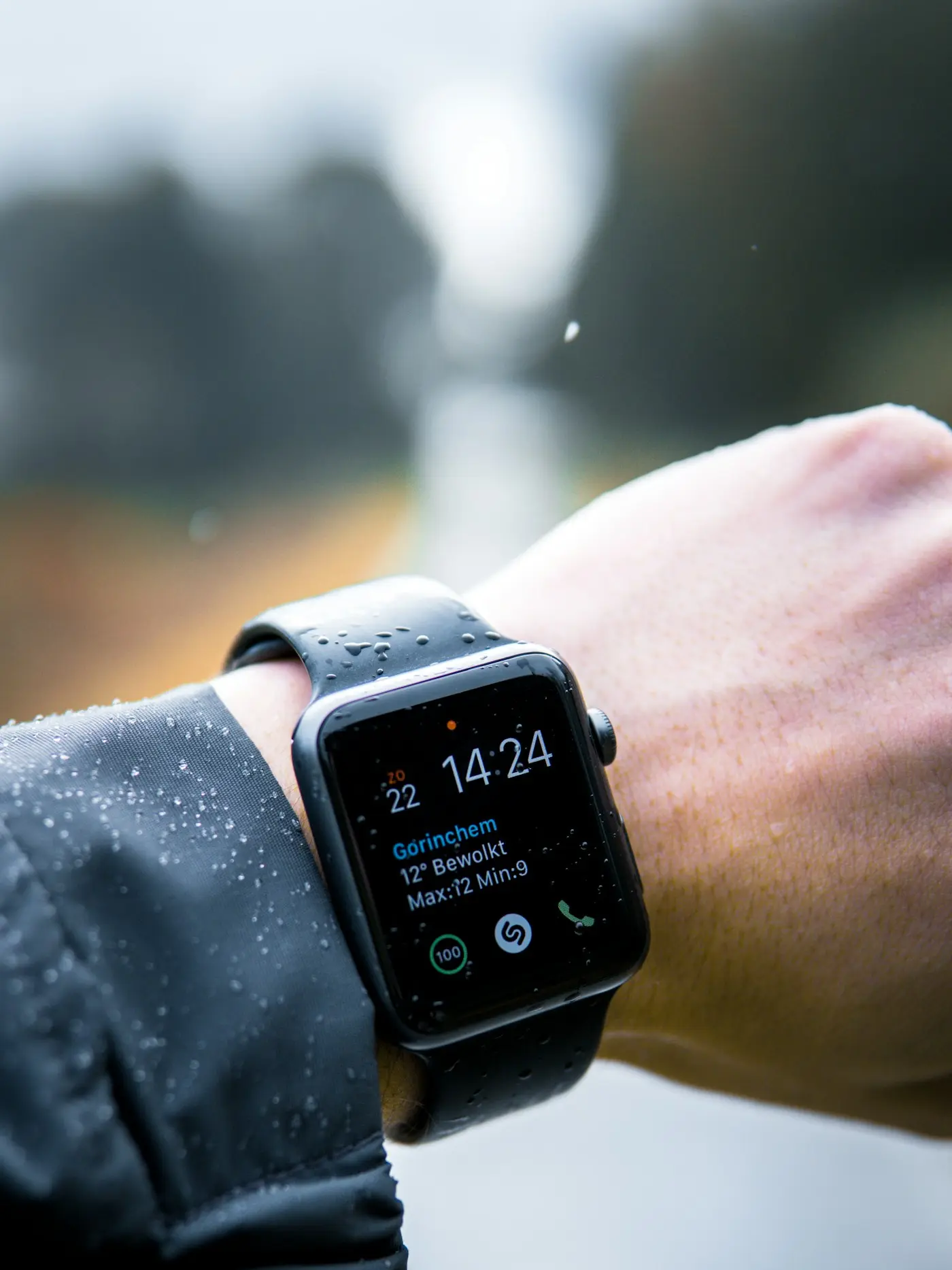 A smartwatch worn on a wrist, showing the time on its display.